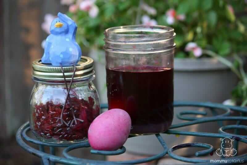 Jar of beetroot juice and vinegar and a dyed pink egg