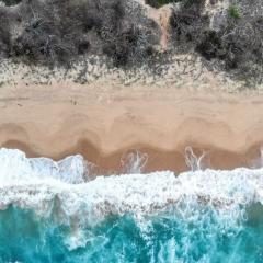 Drone view of ocean waves crashing onshore