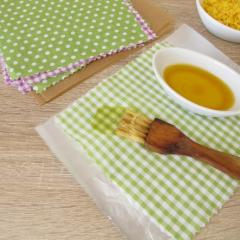 Image of beeswax wraps being made with beeswax pellets, baking paper and cotton fabric
