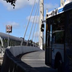 Image of a public bus travelling along the Eleanor Schonell Green Bridge