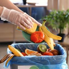 Image of food waste being thrown into the bin